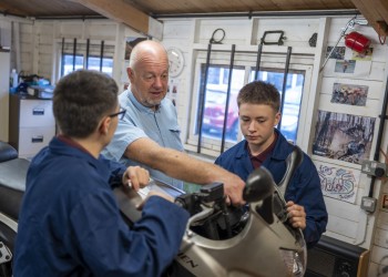 Students working on a motorbike