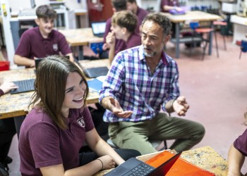 Student laughing with teacher