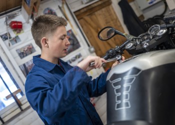 Student working on a motorbike